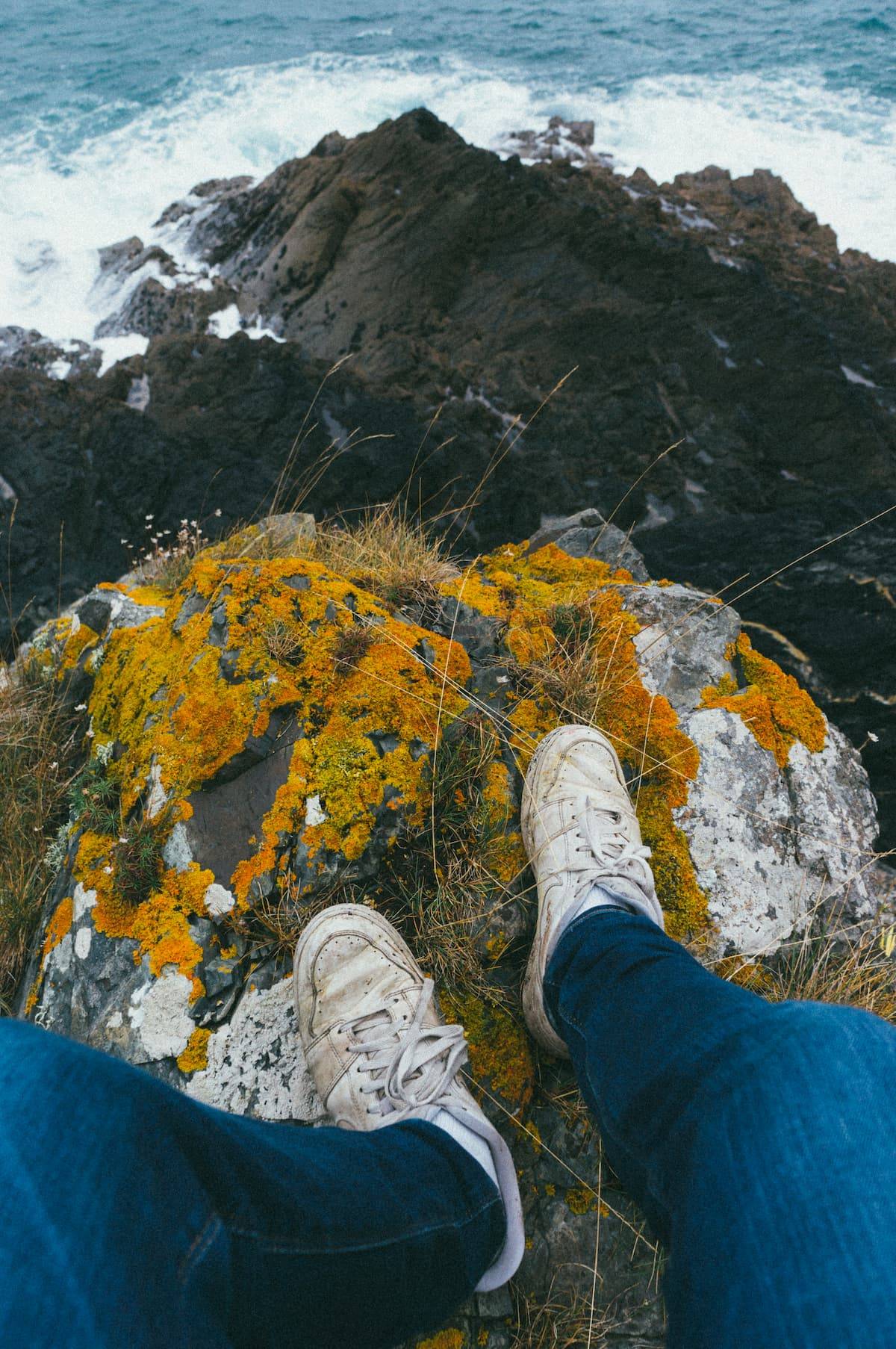 Vertical shot person s feet standing top cliff covered with moss%20(1) - Attribut alt par défaut.